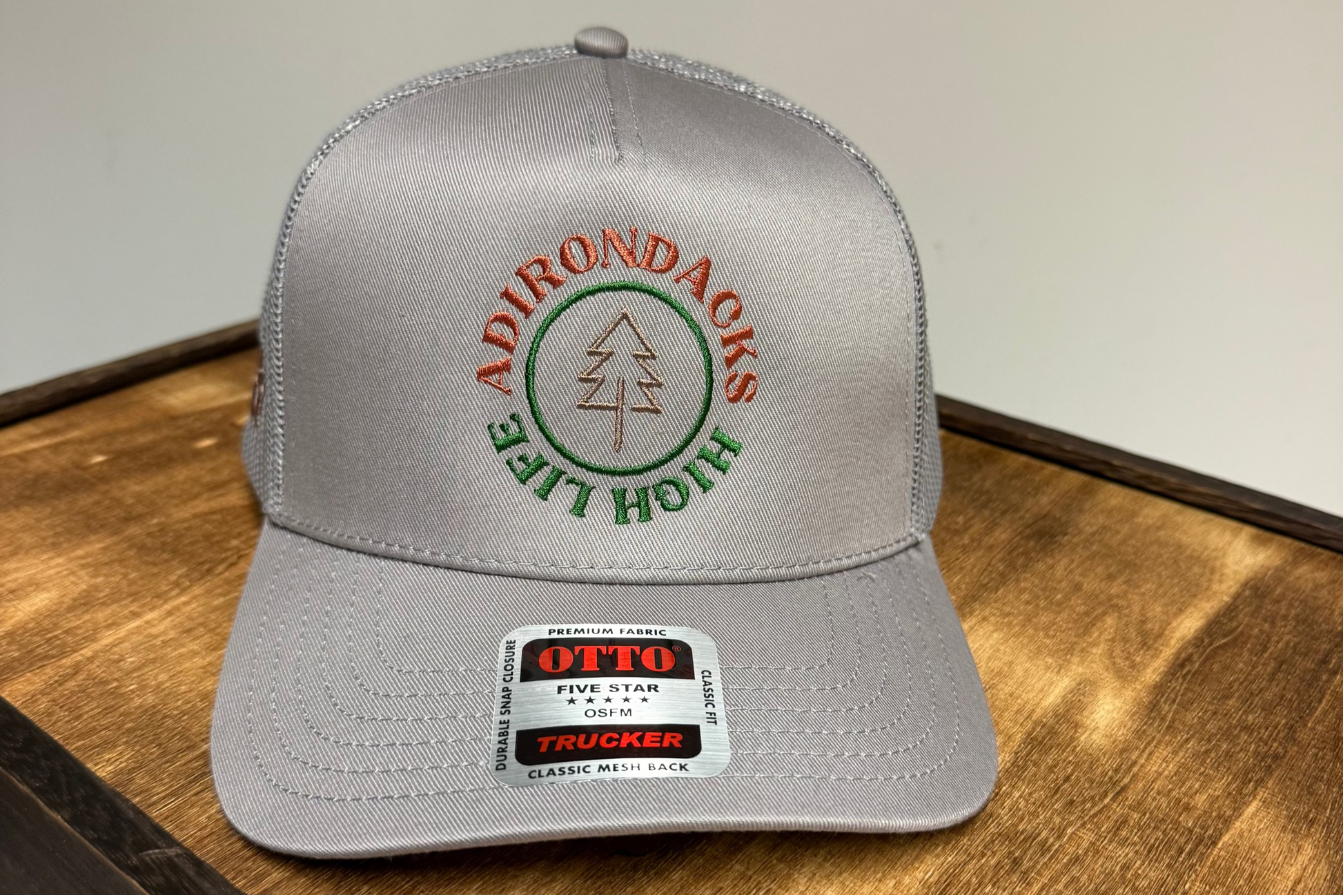 Gray cap with Adirondacks logo on a wooden surface